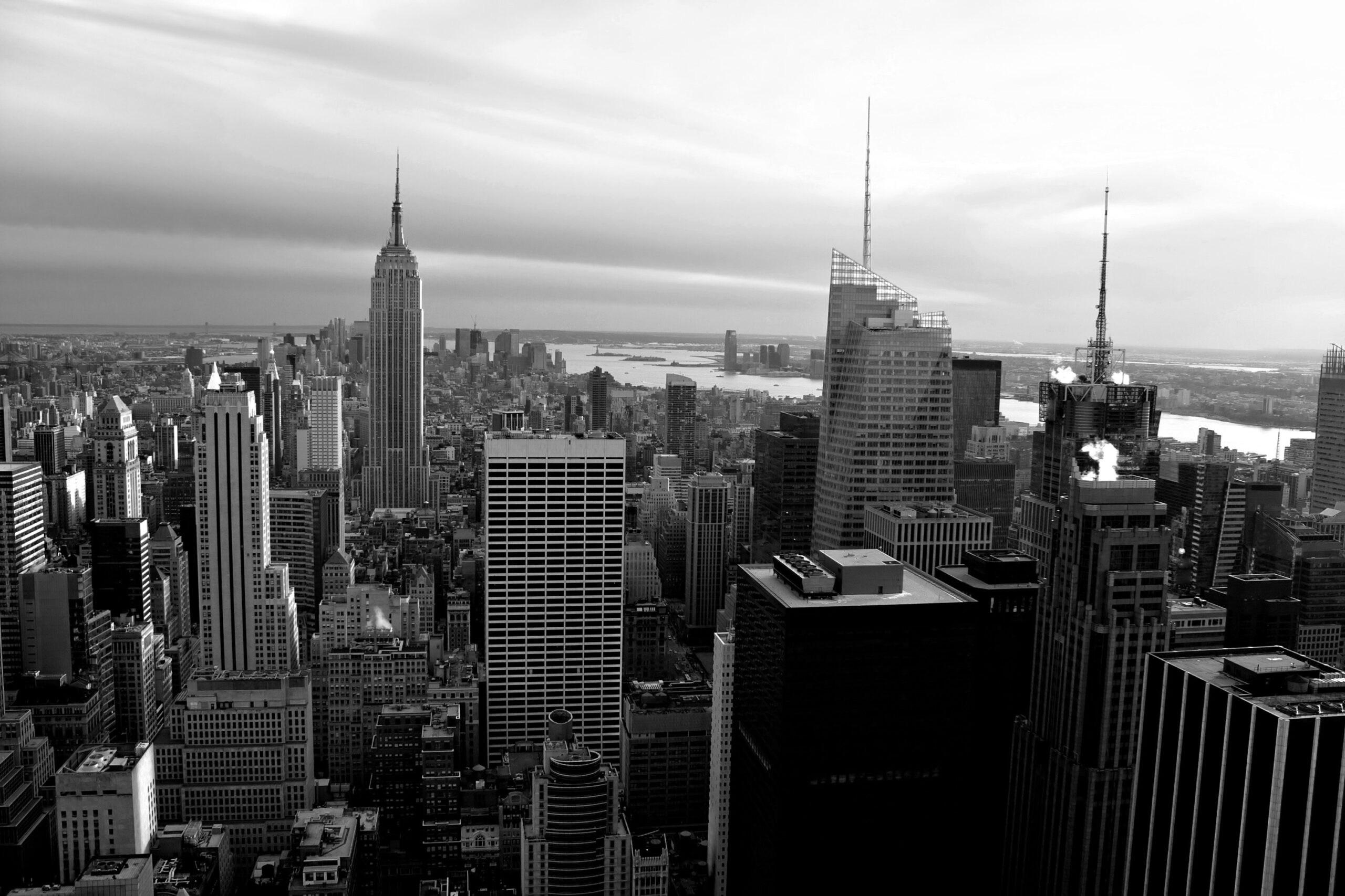 Free stock photos for commercial use. Horizontal aerial view of the Manhattan section of New York City including all of the buildings and skyline in black and white.