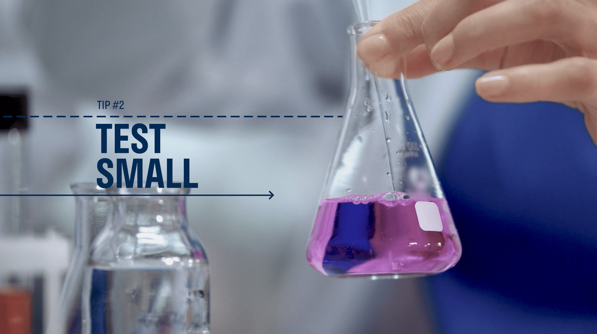 Image of a hand holding a science beaker with pink liquid with dark blue text that reads Tip 2 Test Small. How to use audience testing to improve your videos.